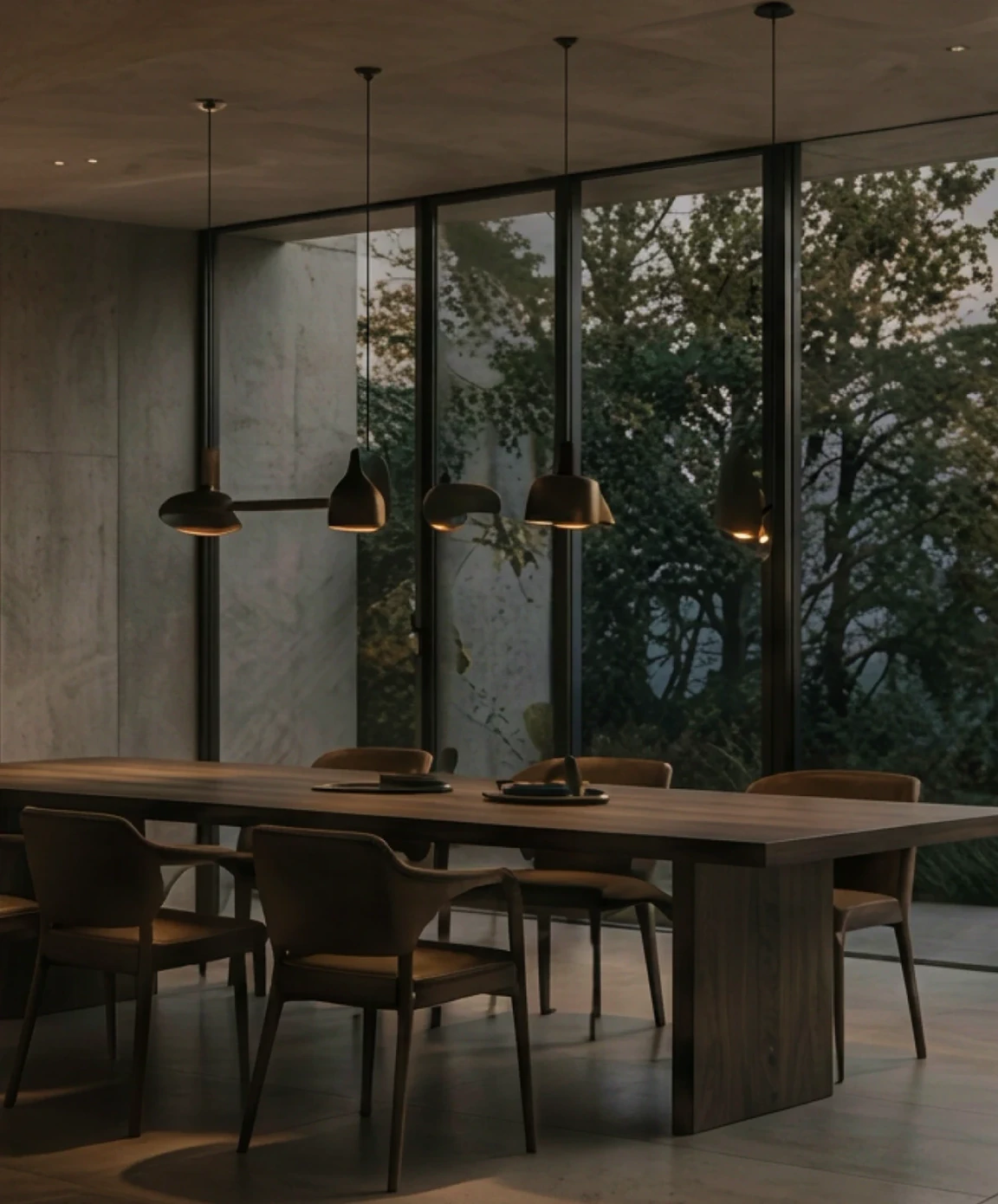 Dining room with pendant lights facing woodland
